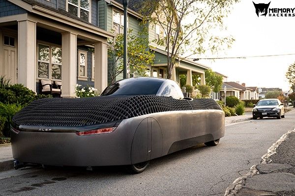 Alef real flying car model parked near a house.jpg